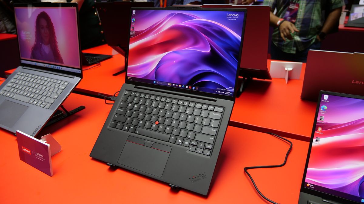 October Prime Day laptop deals Images of the Lenovo ThinkPad X1 Carbon Gen 13 Aura Edition on a red table at IFA 2024