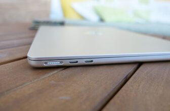 MacBook Air 13 M3 closed on a slatted wooden table showing the ports and overall thinness