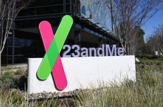 A sign with the 23andMe logo placed in front of a building that serves as the company's headquarters.