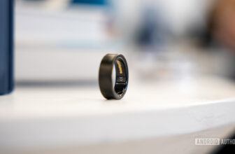 A Samsung Galaxy Ring in a Black Titanium finish rests on a table.