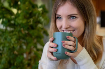 Woman drinking from green Ember Mug 2