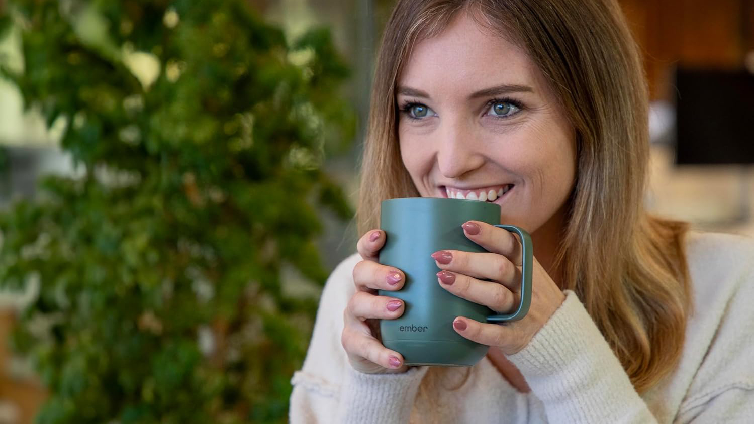 Woman drinking from green Ember Mug 2
