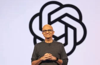 Satya Nadella standing on stage in front of the OpenAI logo during a Microsoft event.